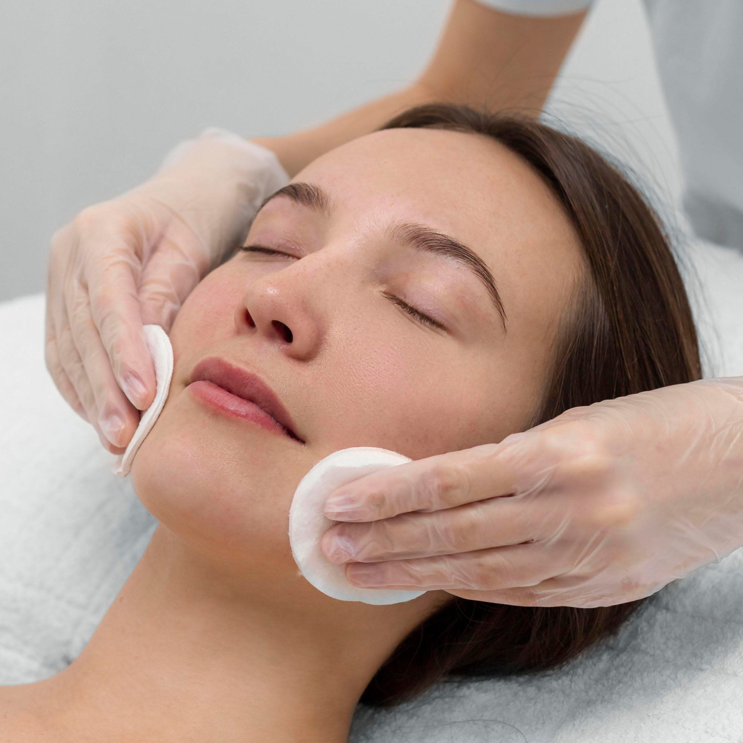 The beautiful female face. The perfect and clean skin of face on gray