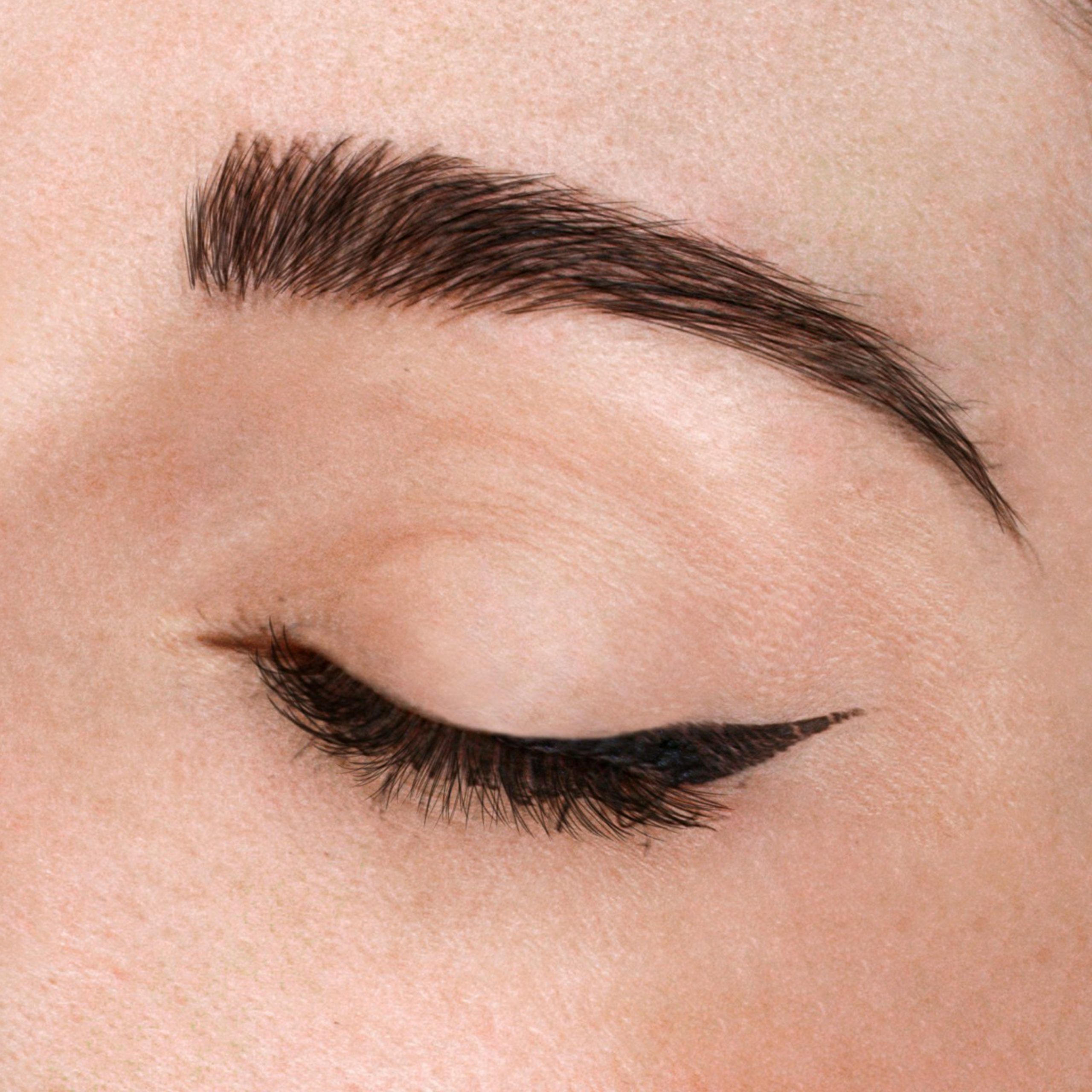The beautiful female face. The perfect and clean skin of face on gray