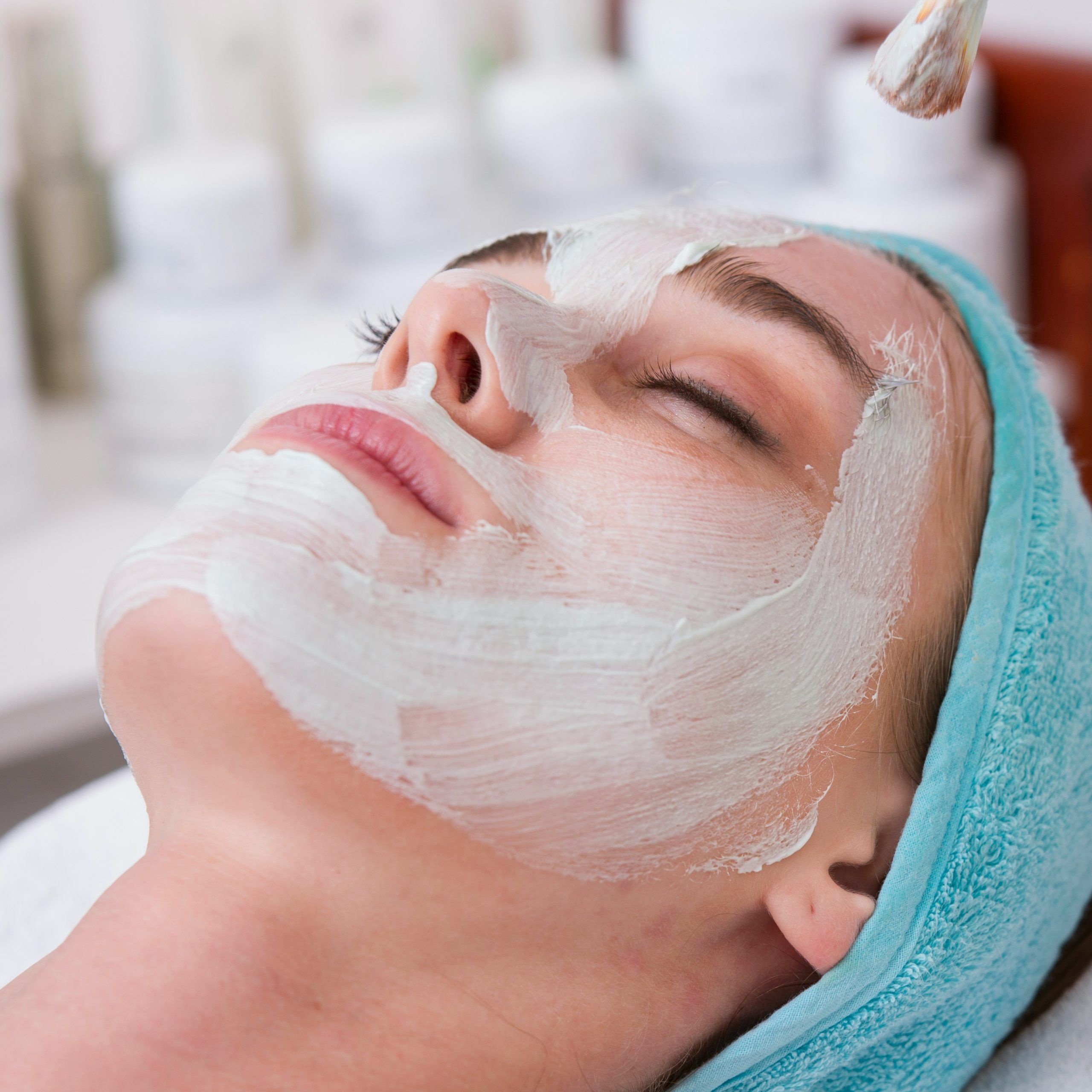 The beautiful female face. The perfect and clean skin of face on gray