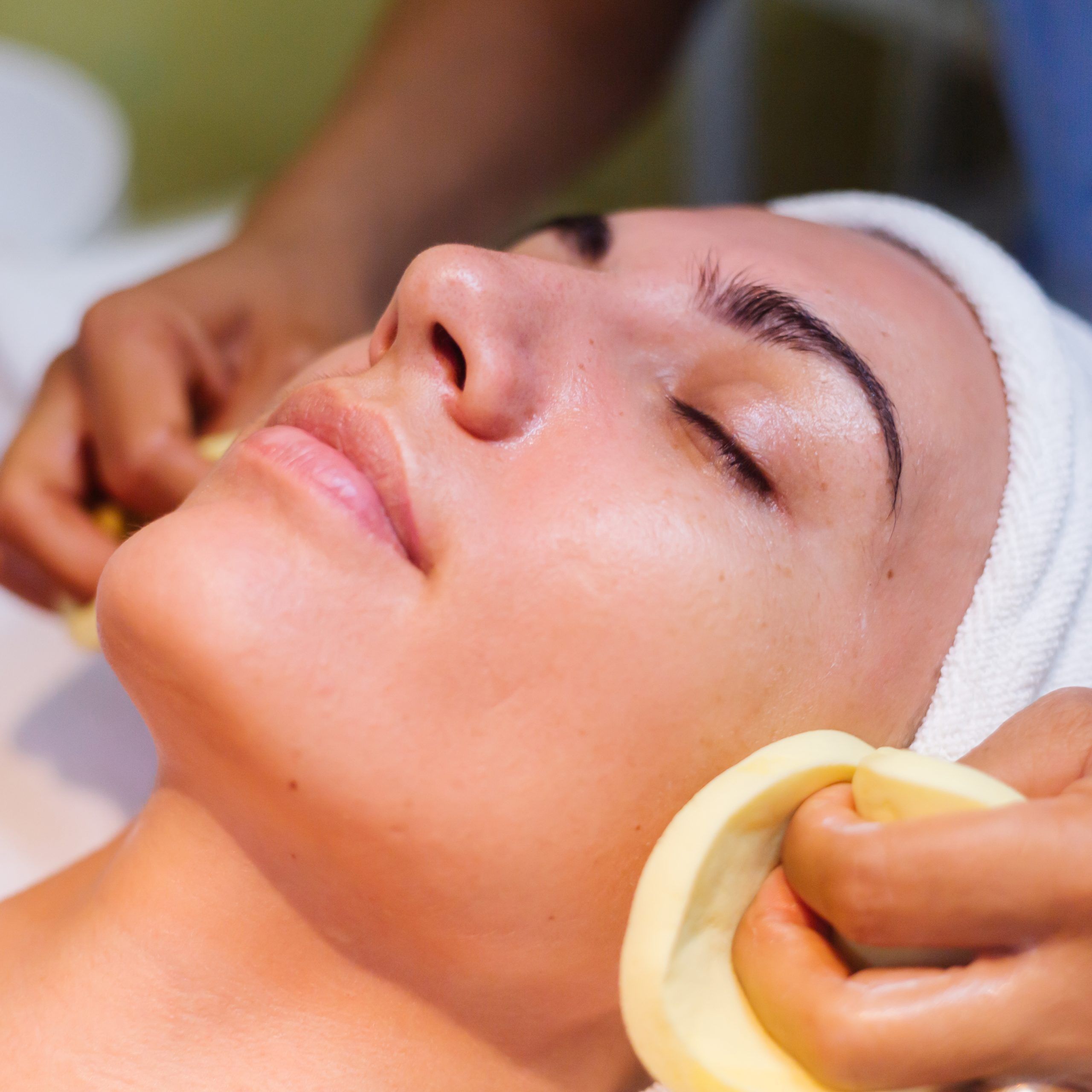 The beautiful female face. The perfect and clean skin of face on gray